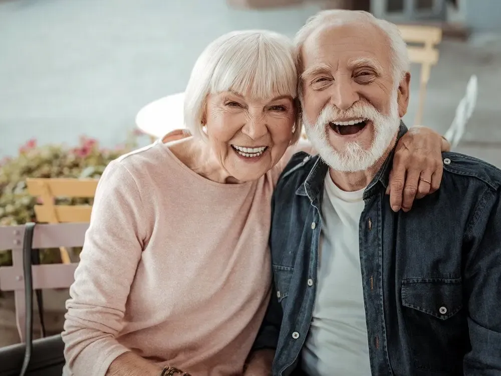 Older man and woman playing table tennis
